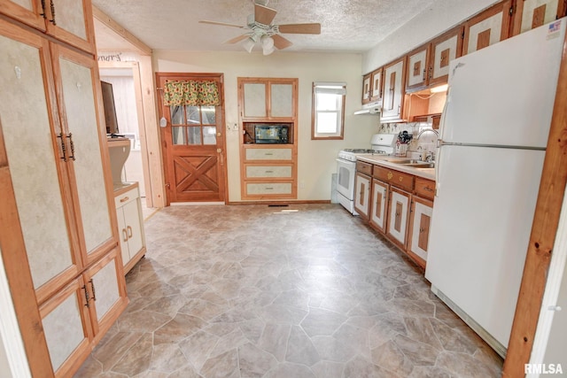 128 Macarthur Blvd, Pana, IL 62557 - kitchen featuring white appliances, a sink, a ceiling fan, light stone finish floors, and a textured ceiling