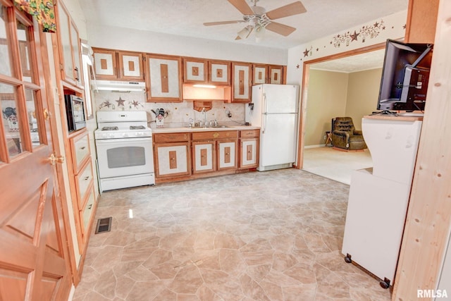 128 Macarthur Blvd, Pana, IL 62557 - kitchen featuring white appliances, under cabinet range hood, a sink, a ceiling fan, and light countertops