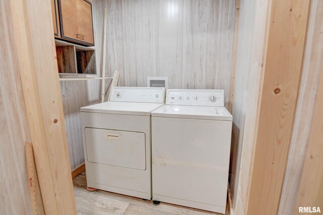 128 Macarthur Blvd, Pana, IL 62557 - laundry area with cabinet space, washer and clothes dryer, and light wood finished floors