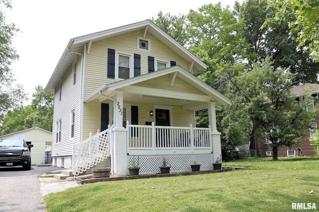 2531 Yale Blvd, Springfield, IL 62703 - american foursquare style home with covered porch, a front lawn, and a garage