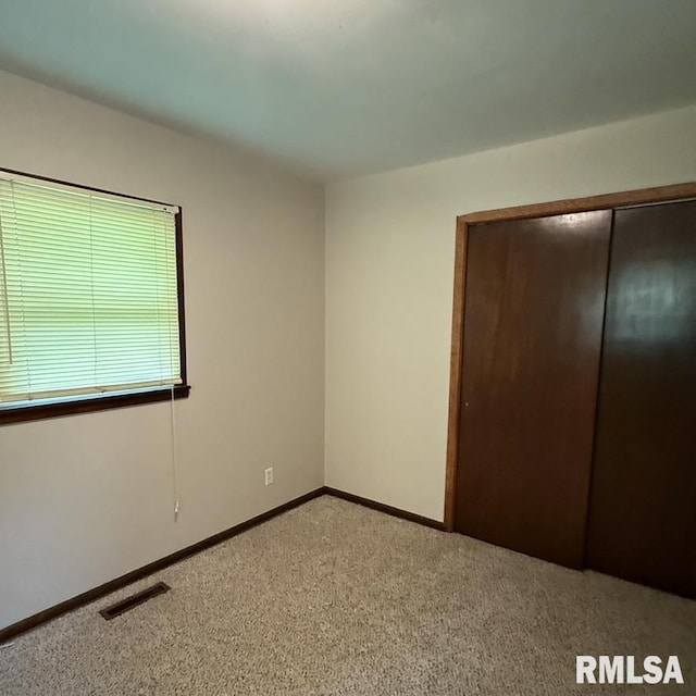 504 W Chestnut St, Chatham, IL 62629 - unfurnished bedroom featuring light carpet, a closet, and baseboards
