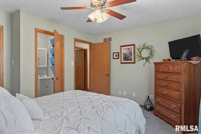 122 W Chapin St, Litchfield, IL 62056 - bedroom featuring carpet, a sink, a textured ceiling, ceiling fan, and connected bathroom