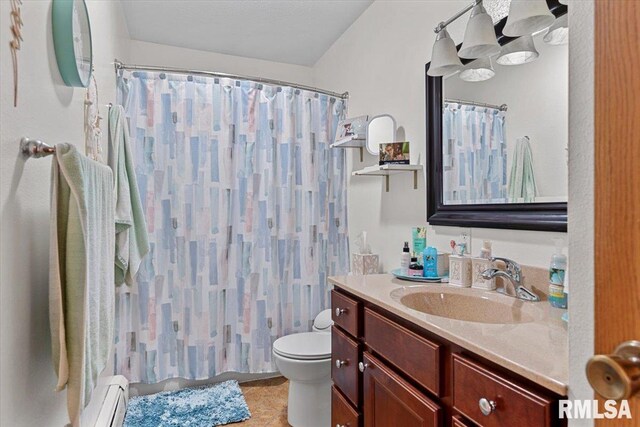 122 W Chapin St, Litchfield, IL 62056 - full bathroom featuring a baseboard radiator, toilet, vanity, a shower with curtain, and tile patterned floors