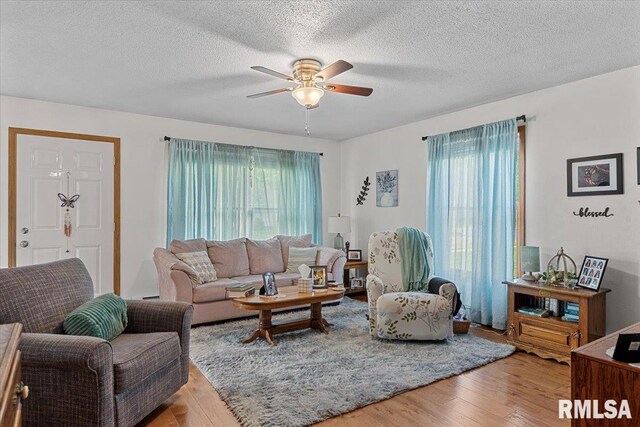 122 W Chapin St, Litchfield, IL 62056 - living area featuring ceiling fan, healthy amount of natural light, wood finished floors, and a textured ceiling