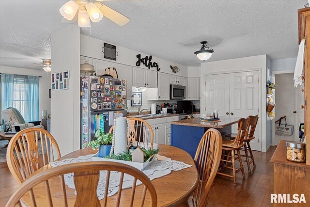 122 W Chapin St, Litchfield, IL 62056 - dining space featuring a ceiling fan, a textured ceiling, and light wood-style flooring
