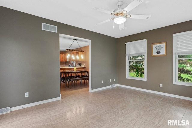 136 Lilac Ln, Chatham, IL 62629 - empty room with baseboards, a ceiling fan, and a chandelier