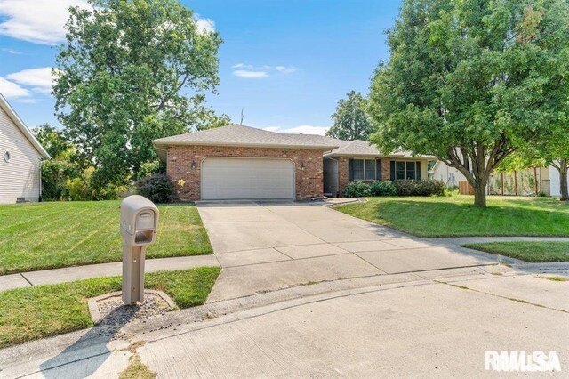 136 Lilac Ln, Chatham, IL 62629 - single story home with brick siding, an attached garage, a front lawn, and driveway