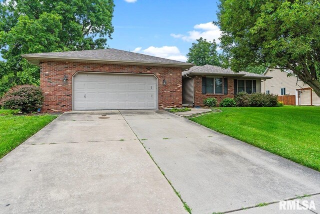 136 Lilac Ln, Chatham, IL 62629 - ranch-style house featuring an attached garage, driveway, brick siding, and a front yard