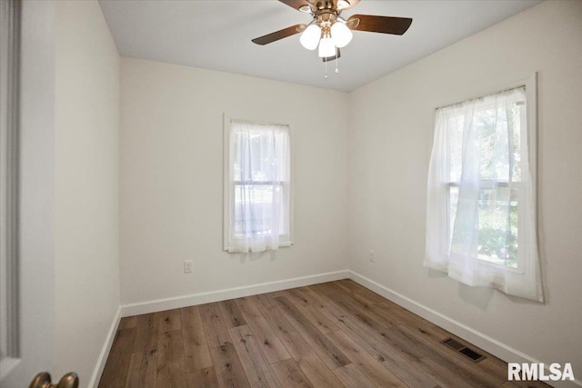 3024 Allis St, Springfield, IL 62703 - unfurnished room with healthy amount of natural light, wood finished floors, baseboards, and a ceiling fan