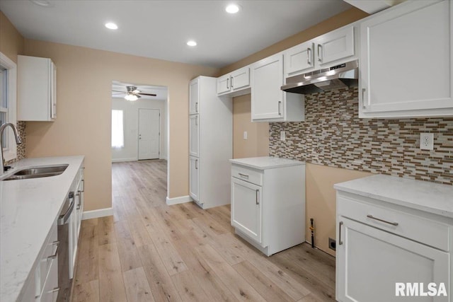 3024 Allis St, Springfield, IL 62703 - kitchen featuring a sink, under cabinet range hood, ceiling fan, light wood-style floors, and backsplash