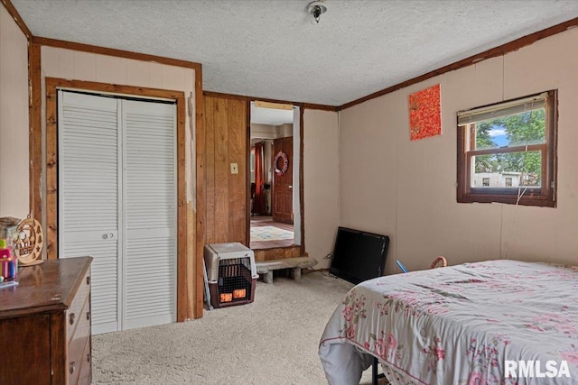 417 W Franklin St, Girard, IL 62640 - carpeted bedroom with crown molding, a textured ceiling, wood walls, and a closet