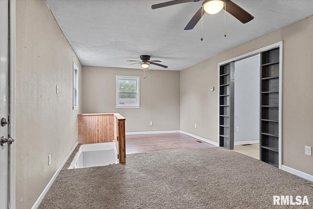 417 W Franklin St, Girard, IL 62640 - carpeted spare room with a ceiling fan, baseboards, a textured ceiling, a textured wall, and built in features