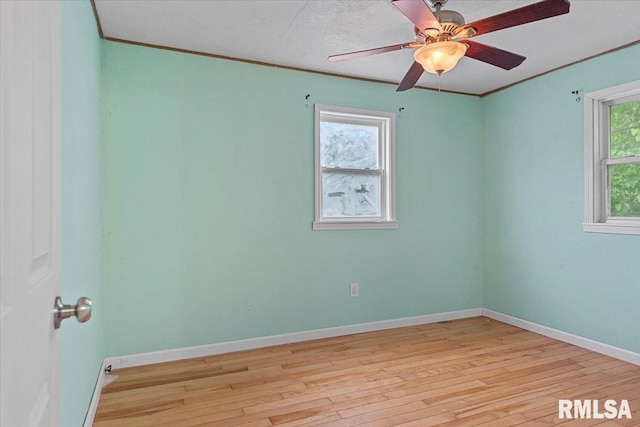417 W Franklin St, Girard, IL 62640 - spare room with light wood finished floors, baseboards, crown molding, and ceiling fan