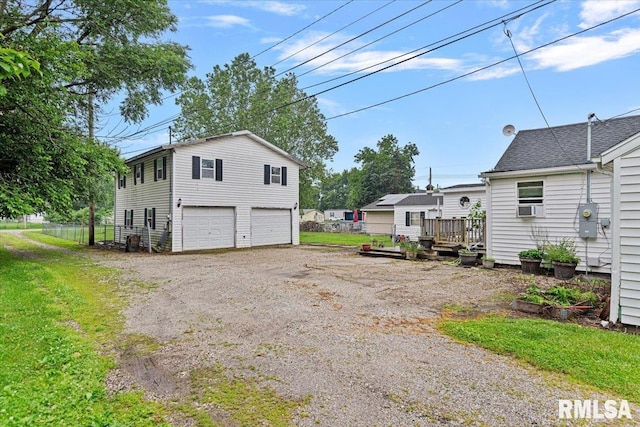 417 W Franklin St, Girard, IL 62640 - view of side of home with a detached garage, cooling unit, and a wooden deck