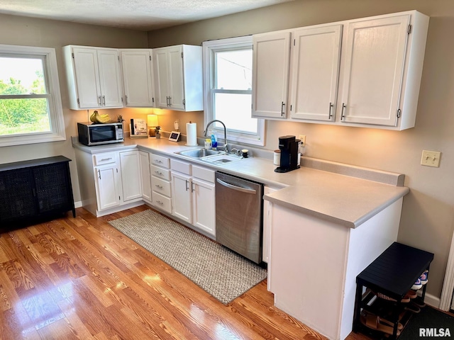 2900 Old State Rd, Alexander, IL 62601 - kitchen with stainless steel appliances, a sink, light wood-style floors, light countertops, and white cabinets