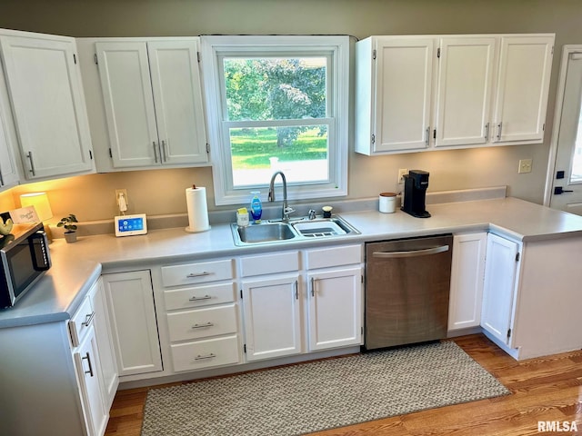 2900 Old State Rd, Alexander, IL 62601 - kitchen featuring appliances with stainless steel finishes, a sink, white cabinetry, and light wood-type flooring