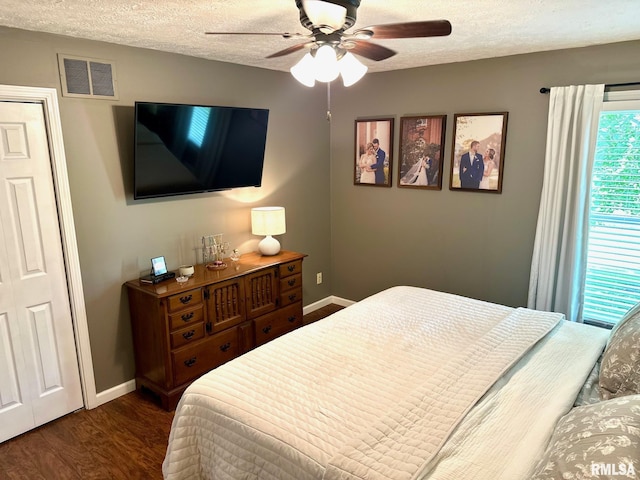 2900 Old State Rd, Alexander, IL 62601 - bedroom featuring baseboards, dark wood-type flooring, a textured ceiling, and a ceiling fan