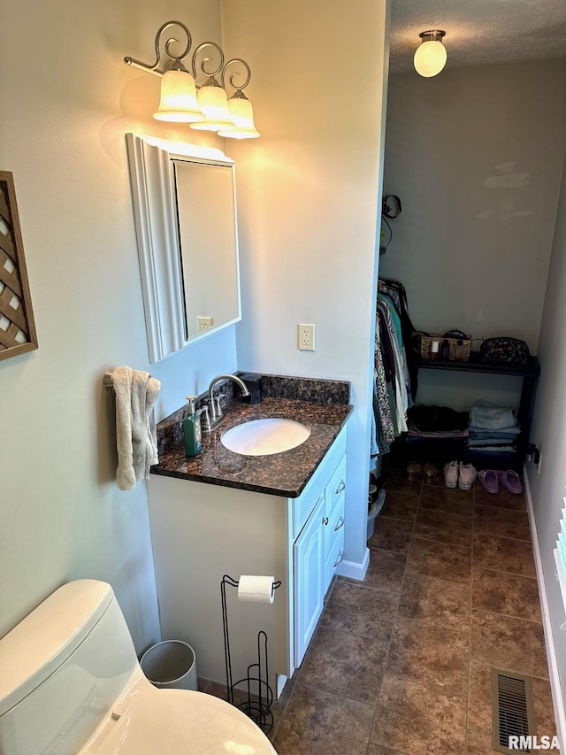 2900 Old State Rd, Alexander, IL 62601 - bathroom with toilet, vanity, and baseboards