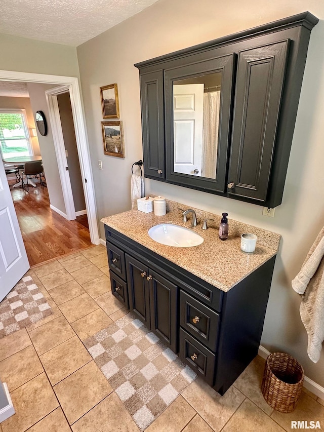 2900 Old State Rd, Alexander, IL 62601 - bathroom featuring vanity, baseboards, tile patterned flooring, and a textured ceiling