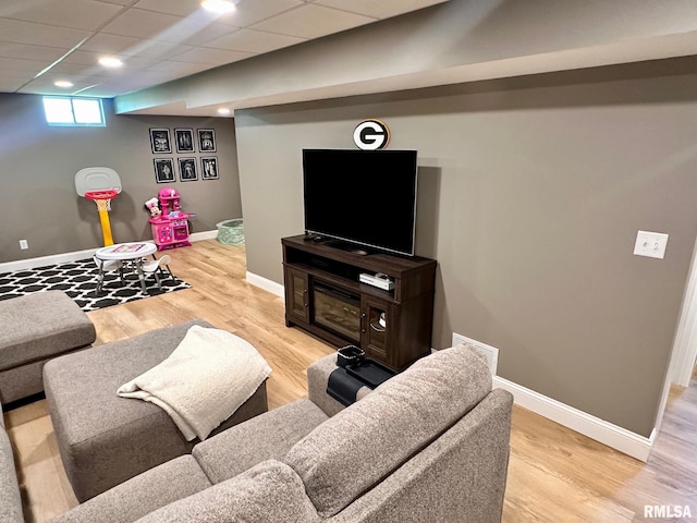2900 Old State Rd, Alexander, IL 62601 - living room featuring baseboards, light wood-type flooring, and a drop ceiling