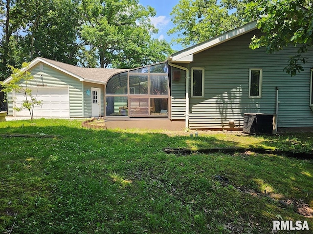 12862 Winnebago Dr, Plainview, IL 62685 - rear view of house with a yard and a detached garage