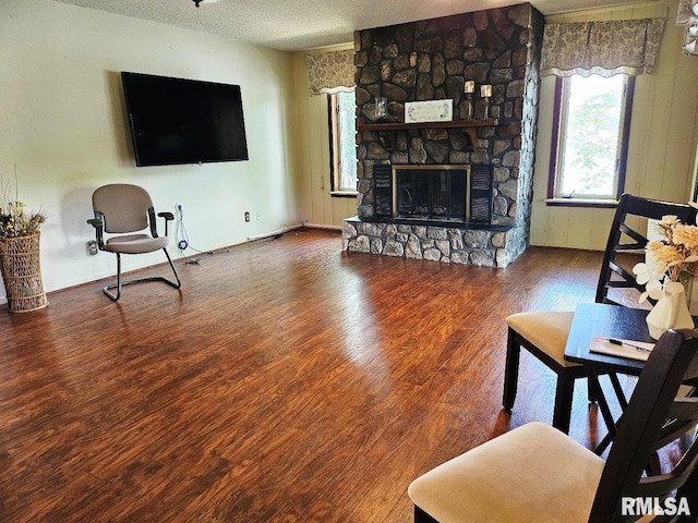 12862 Winnebago Dr, Plainview, IL 62685 - living room with a textured ceiling, wood finished floors, and a fireplace