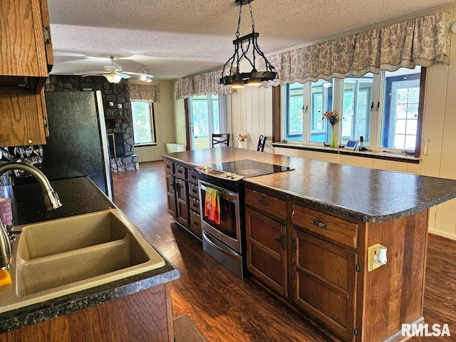 12862 Winnebago Dr, Plainview, IL 62685 - kitchen featuring a sink, stainless steel appliances, dark wood-style floors, a textured ceiling, and dark countertops