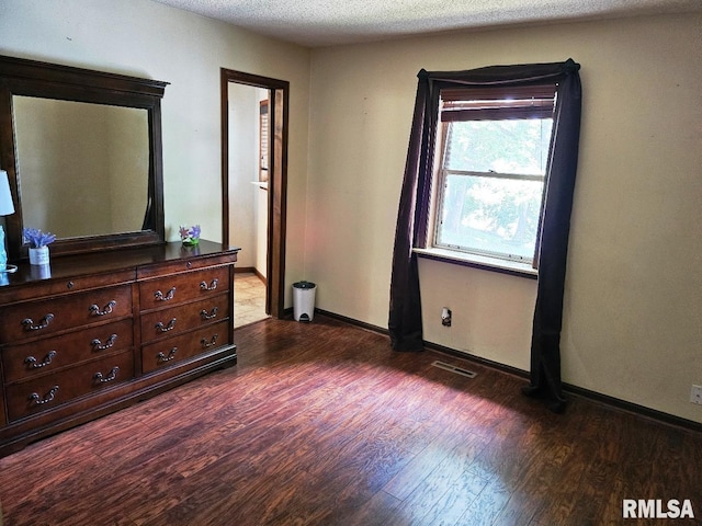 12862 Winnebago Dr, Plainview, IL 62685 - bedroom featuring dark wood-type flooring, baseboards, and a textured ceiling
