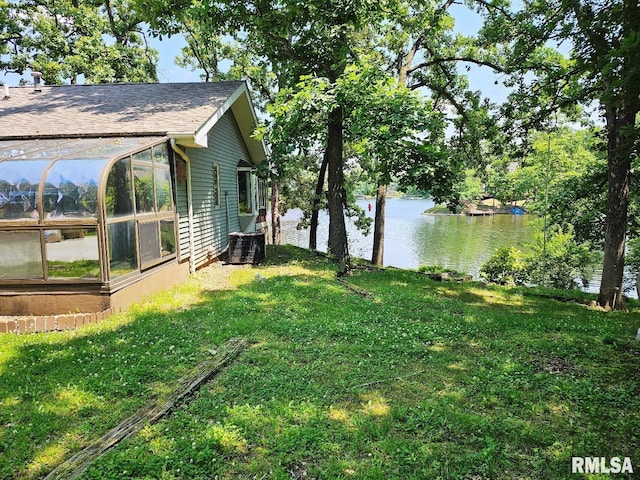12862 Winnebago Dr, Plainview, IL 62685 - view of grassy yard with a water view, cooling unit, and a sunroom
