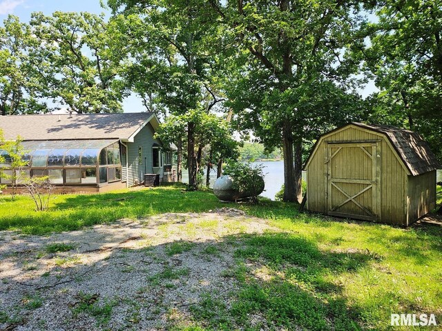 12862 Winnebago Dr, Plainview, IL 62685 - view of green lawn with a greenhouse