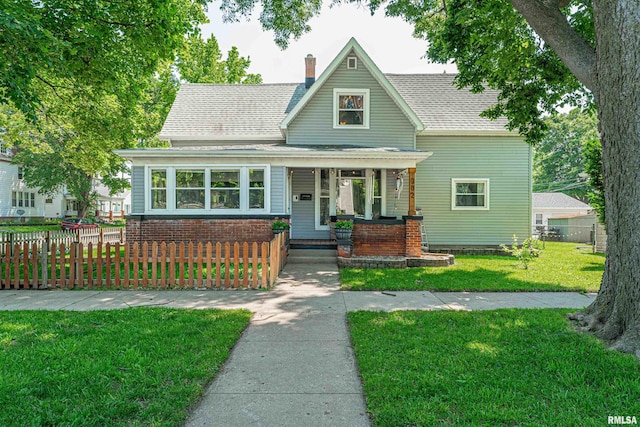 302 S Center St, Clinton, IL 61727 - view of front of home with a porch, roof with shingles, and a chimney