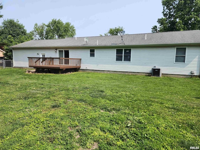 208 Elm St, Dawson, IL 62520 - back of property featuring a wooden deck, a lawn, and central AC unit