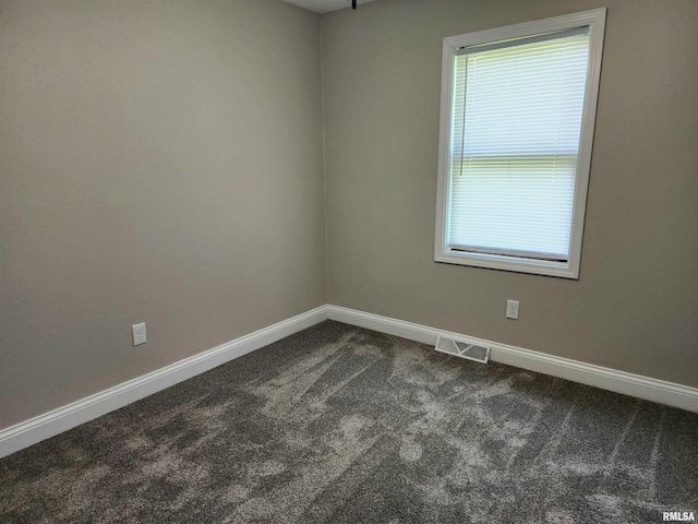 208 Elm St, Dawson, IL 62520 - spare room featuring dark colored carpet and baseboards