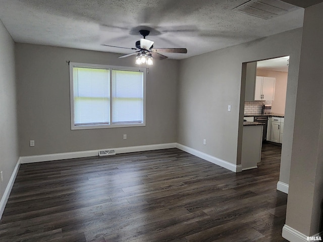 208 Elm St, Dawson, IL 62520 - spare room with ceiling fan, dark wood-type flooring, a textured ceiling, and baseboards