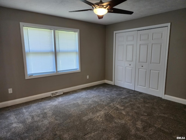208 Elm St, Dawson, IL 62520 - unfurnished bedroom featuring dark carpet, baseboards, a closet, and ceiling fan
