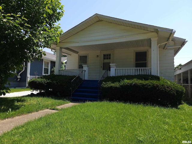 2240 Holmes Ave, Springfield, IL 62704 - bungalow-style house featuring a front lawn and a porch