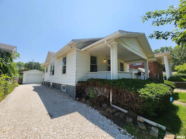 2240 Holmes Ave, Springfield, IL 62704 - view of front of home featuring driveway, a garage, an outdoor structure, and a porch