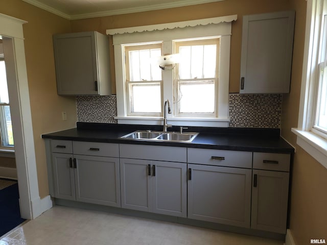 2240 Holmes Ave, Springfield, IL 62704 - kitchen featuring dark countertops, tasteful backsplash, ornamental molding, and gray cabinetry