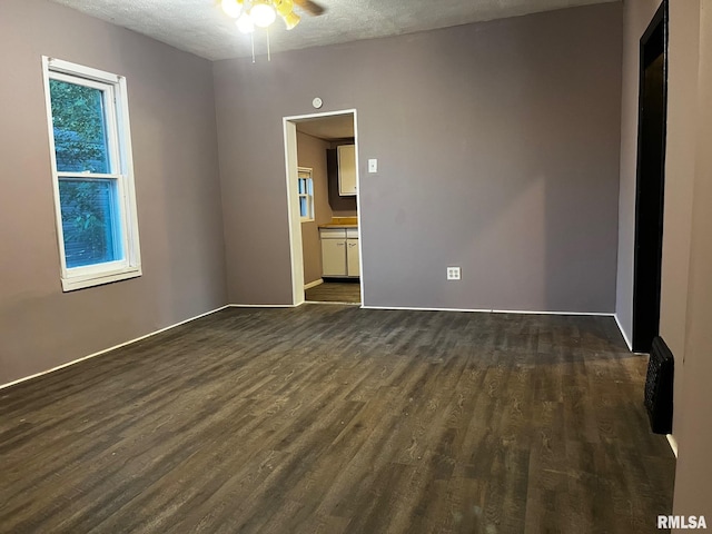 3208 E Elm St, Springfield, IL 62702 - unfurnished room with dark wood-type flooring, a ceiling fan, and a textured ceiling