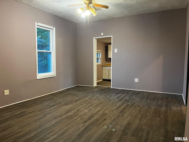 3208 E Elm St, Springfield, IL 62702 - unfurnished room featuring ceiling fan, dark wood-style flooring, and a textured ceiling