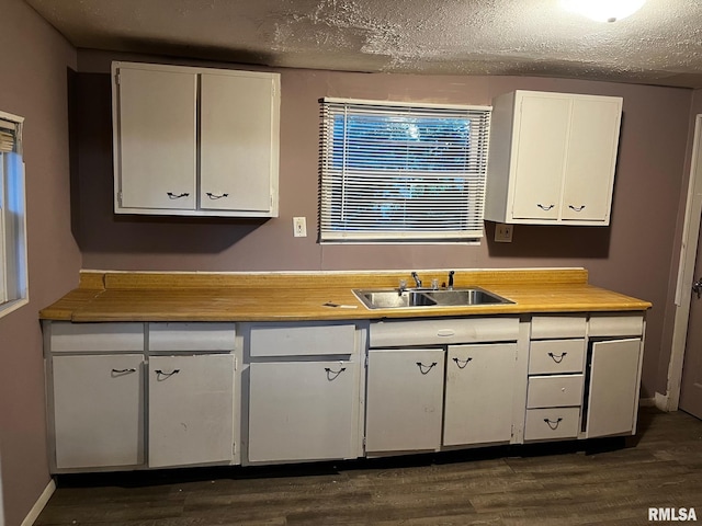 3208 E Elm St, Springfield, IL 62702 - kitchen with white cabinetry, dark wood-style flooring, light countertops, and a textured ceiling