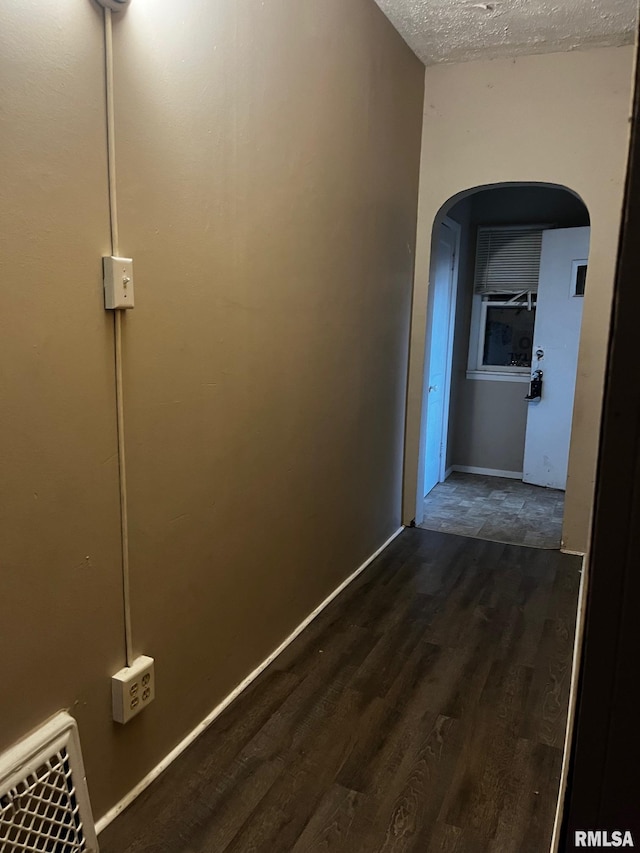 3208 E Elm St, Springfield, IL 62702 - corridor with arched walkways, dark wood-style floors, and a textured ceiling