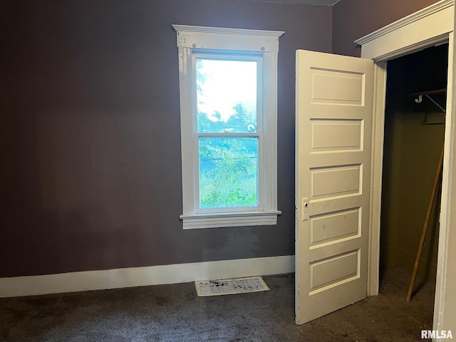3208 E Elm St, Springfield, IL 62702 - unfurnished bedroom featuring multiple windows and dark colored carpet