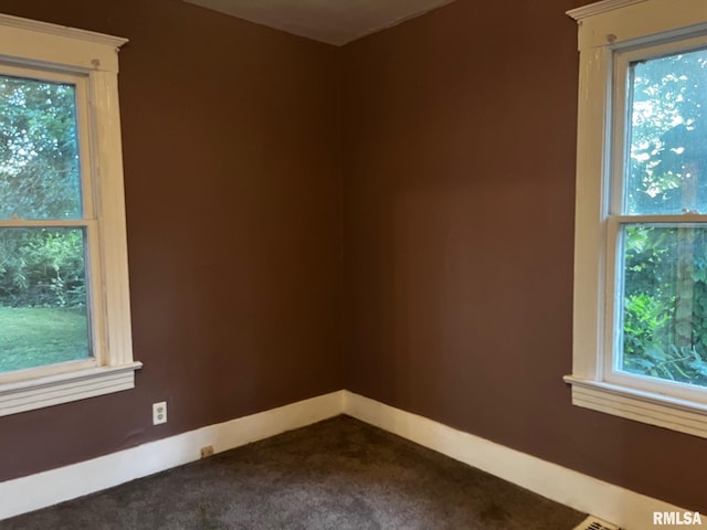 3208 E Elm St, Springfield, IL 62702 - spare room featuring dark carpet and baseboards