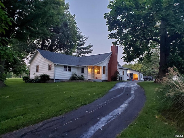 7096 Bahr Rd, Sherman, IL 62684 - ranch-style house featuring a chimney, a front yard, and asphalt driveway