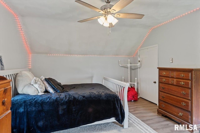 14455 E Dutch Henry Rd, Lewistown, IL 61542 - bedroom featuring lofted ceiling, light wood finished floors, and a ceiling fan