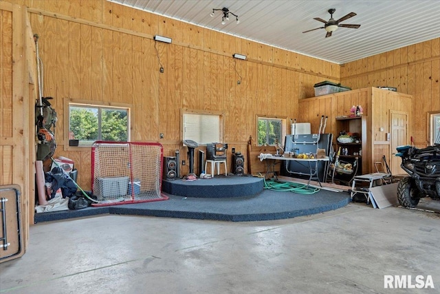 14455 E Dutch Henry Rd, Lewistown, IL 61542 - garage featuring wood walls and a ceiling fan