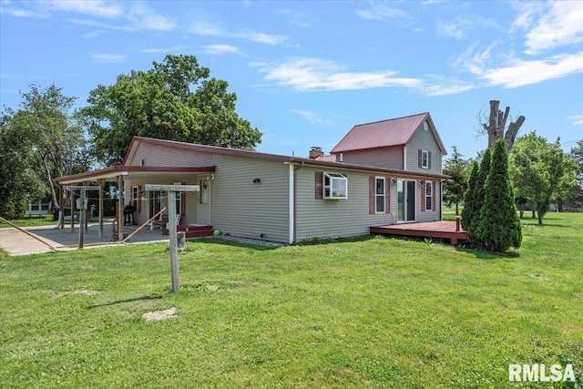 14455 E Dutch Henry Rd, Lewistown, IL 61542 - rear view of house with a deck, a patio area, a lawn, and a chimney