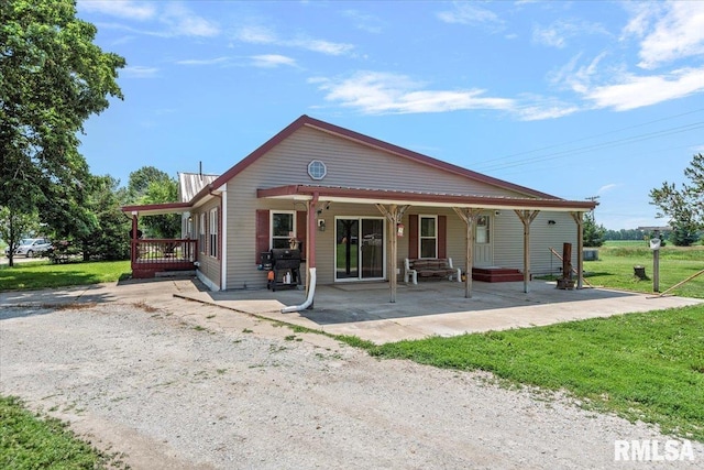 14455 E Dutch Henry Rd, Lewistown, IL 61542 - rear view of property featuring a patio and a lawn