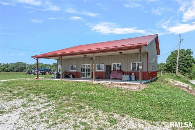 14455 E Dutch Henry Rd, Lewistown, IL 61542 - rear view of property with a lawn, metal roof, and a patio